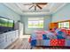 Bedroom with trey ceiling, ceiling fan, and lots of natural light at 644 Chipper Dr, Sun City Center, FL 33573