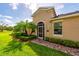 Charming home featuring a screened entry, arched doorway, landscaped garden, and a red brick walkway at 644 Chipper Dr, Sun City Center, FL 33573