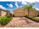 Beautiful home with a brick paved driveway and mature landscaping at 644 Chipper Dr, Sun City Center, FL 33573