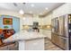 Kitchen island with granite countertop, stainless steel appliances and wood flooring at 644 Chipper Dr, Sun City Center, FL 33573