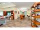Open-concept living area featuring wood-look tile flooring, dining area, and recessed lighting at 644 Chipper Dr, Sun City Center, FL 33573