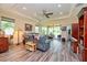 Bright living room featuring tile floors, a ceiling fan, recessed lighting, and sliding glass doors to the lanai at 644 Chipper Dr, Sun City Center, FL 33573