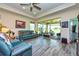 Spacious living room with tile floors, recessed lights, comfortable seating, and a view of the screened lanai at 644 Chipper Dr, Sun City Center, FL 33573
