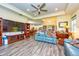 Open-concept living room with ceiling fan, tile floors, and views into the kitchen at 644 Chipper Dr, Sun City Center, FL 33573