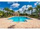 Community pool with lots of lounge chairs and palm tree landscaping at 644 Chipper Dr, Sun City Center, FL 33573