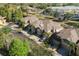 Aerial view of townhomes with garages, surrounded by trees, close to parking at 6677 84Th N Ave, Pinellas Park, FL 33781