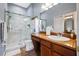 Modern bathroom with glass-enclosed shower, sleek vanity, and ample cabinet space at 6677 84Th N Ave, Pinellas Park, FL 33781