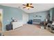 Light and airy Bedroom with cozy glider, changing table, and a serene color palette at 6677 84Th N Ave, Pinellas Park, FL 33781