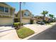 Exterior view of townhomes with garages, palm trees and well-maintained landscaping at 6677 84Th N Ave, Pinellas Park, FL 33781