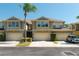 Exterior view of townhomes with garages and manicured lawns on a sunny day at 6677 84Th N Ave, Pinellas Park, FL 33781