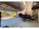 Spacious garage with jet ski, storage and open door to the outdoors at 6677 84Th N Ave, Pinellas Park, FL 33781