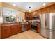 Well-equipped kitchen featuring stainless steel appliances, granite countertops, and wood cabinetry at 6677 84Th N Ave, Pinellas Park, FL 33781