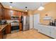 Functional kitchen equipped with stainless steel appliances, wood cabinets, and breakfast bar area at 6677 84Th N Ave, Pinellas Park, FL 33781