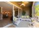 Relaxing screened lanai with stylish wicker furniture and sliding glass doors to the home's interior at 6677 84Th N Ave, Pinellas Park, FL 33781