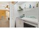 Convenient laundry room with modern washer and dryer units, plus overhead storage shelf at 6677 84Th N Ave, Pinellas Park, FL 33781