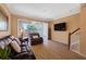 Cozy living room with plush seating, neutral tones, wood floors, and a sliding glass door to the outdoor living area at 6677 84Th N Ave, Pinellas Park, FL 33781