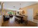 Open-concept living area with wood floors and natural light, seamlessly connecting to the dining and kitchen areas at 6677 84Th N Ave, Pinellas Park, FL 33781