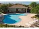 Community pool featuring lounge chairs, covered tables and a lush landscaped view at 6677 84Th N Ave, Pinellas Park, FL 33781