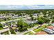 Bird's eye view of a neighborhood with a featured home surrounded by lush greenery and mature trees at 729 89Th N Ave, St Petersburg, FL 33702