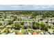 Aerial view of a lovely home nestled within a leafy neighborhood, highlighted by a vibrant green canopy of mature trees at 729 89Th N Ave, St Petersburg, FL 33702