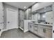 Modern bathroom featuring a glass walk-in shower, gray tiling, double vanity, and granite countertops at 729 89Th N Ave, St Petersburg, FL 33702