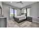 This bedroom is styled with grey decor, wood floors, curtains, and a ceiling fan at 729 89Th N Ave, St Petersburg, FL 33702