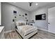 Well-lit bedroom featuring wall decor, a white bed set, a ceiling fan, and wall shelving at 729 89Th N Ave, St Petersburg, FL 33702