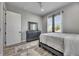 This bedroom is styled with grey walls and decor, wood floors, curtains, and a ceiling fan at 729 89Th N Ave, St Petersburg, FL 33702