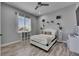 Cozy bedroom with a ceiling fan, one large window, and white decor accents at 729 89Th N Ave, St Petersburg, FL 33702