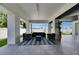 Relaxing covered patio with comfortable seating and stylish rug at 729 89Th N Ave, St Petersburg, FL 33702