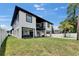 Contemporary two-story home with a balcony, open carport, and spacious backyard at 729 89Th N Ave, St Petersburg, FL 33702