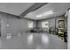 Garage featuring an epoxy floor, neutral tones, and plentiful space for parking and storage of bikes and sports equipment at 729 89Th N Ave, St Petersburg, FL 33702