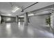 Spacious garage featuring epoxy floors, bright lighting, and neutral color scheme, offering ample room for vehicles and storage at 729 89Th N Ave, St Petersburg, FL 33702