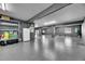 Bright garage showcases updated epoxy flooring, utility shelves, and plenty of space for a workspace and storage at 729 89Th N Ave, St Petersburg, FL 33702