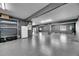 Large garage with epoxy flooring, storage racks, utility connections, and access to the exterior at 729 89Th N Ave, St Petersburg, FL 33702
