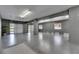Expansive garage area showcasing epoxy flooring, multiple garage doors, and bright interior lighting at 729 89Th N Ave, St Petersburg, FL 33702