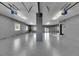 Well-lit garage featuring epoxy flooring, updated garage door mechanisms, and convenient access to the home at 729 89Th N Ave, St Petersburg, FL 33702