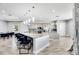 Bright kitchen with stainless steel appliances, granite counters, kitchen island, bar stools, and hardwood flooring at 729 89Th N Ave, St Petersburg, FL 33702