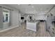 A large open concept kitchen with hardwood floors and stainless steel appliances at 729 89Th N Ave, St Petersburg, FL 33702