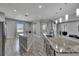 A modern kitchen with dual islands, a black faucet, and light-colored cabinets and floors at 729 89Th N Ave, St Petersburg, FL 33702