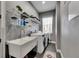Well-organized laundry room with modern washer and dryer, storage shelves, and a utility sink at 729 89Th N Ave, St Petersburg, FL 33702