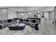 Open-concept living space showcasing a large sectional sofa, modern decor, and seamless flow to the kitchen at 729 89Th N Ave, St Petersburg, FL 33702