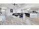 Open-concept living room with modern decor, recessed lights, and kitchen access with bar stool seating at 729 89Th N Ave, St Petersburg, FL 33702