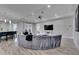 Bright, open living area with bar stool seating at the kitchen island and a circular velvet sofa at 729 89Th N Ave, St Petersburg, FL 33702