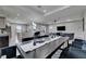 Open layout with modern kitchen, dining table, and living room area featuring recessed lighting and ceiling fan at 729 89Th N Ave, St Petersburg, FL 33702