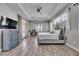This is a large main bedroom with hardwood floors, a tray ceiling, a ceiling fan, and lots of natural light at 729 89Th N Ave, St Petersburg, FL 33702