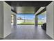 Relaxing covered patio boasts sleek tile flooring and views of the spacious backyard at 729 89Th N Ave, St Petersburg, FL 33702