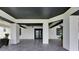Large covered patio with modern tile flooring and structural elements at 729 89Th N Ave, St Petersburg, FL 33702