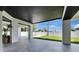 Spacious covered patio featuring sleek tile flooring and backyard views at 729 89Th N Ave, St Petersburg, FL 33702