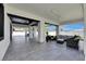 Spacious covered patio with sleek tile flooring and comfortable outdoor seating area at 729 89Th N Ave, St Petersburg, FL 33702